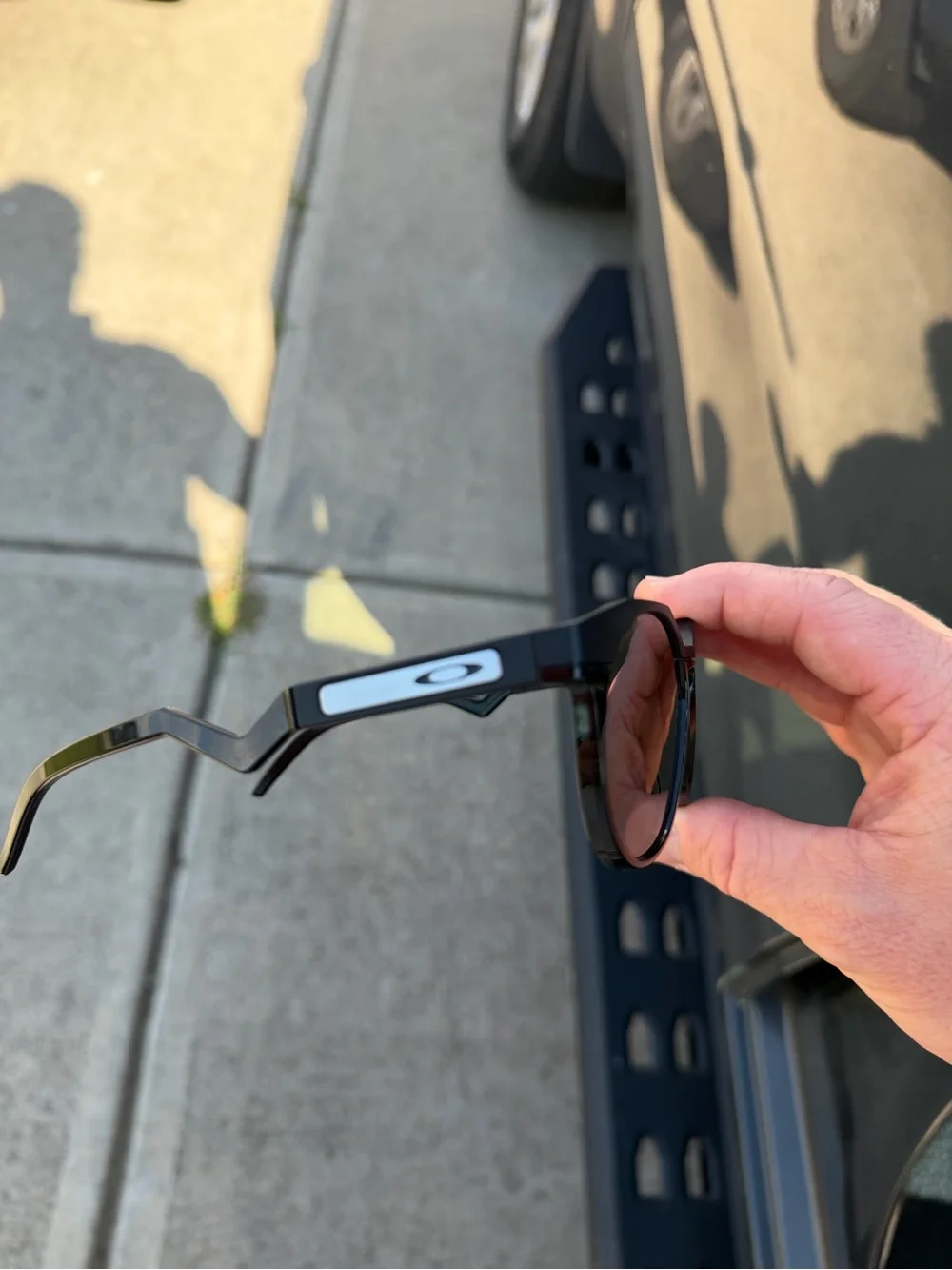 Oakley Men’s Black Round Frame Sunglasses with Silver Logo Accent